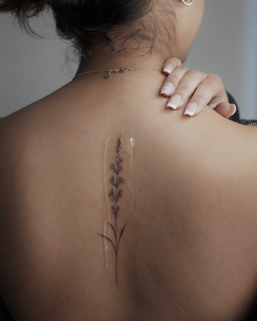 dainty flower tattoo on the back